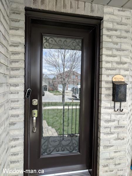 Single entry insulated steel exterior front door. Brown. Port Stanly classic wrought iron full glass insert